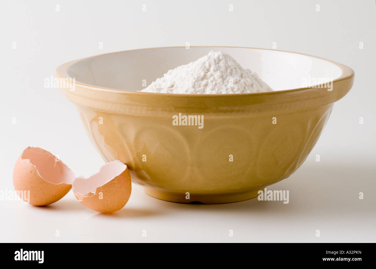 Mixing Bowl with Flour in and Broken Egg Stock Photo