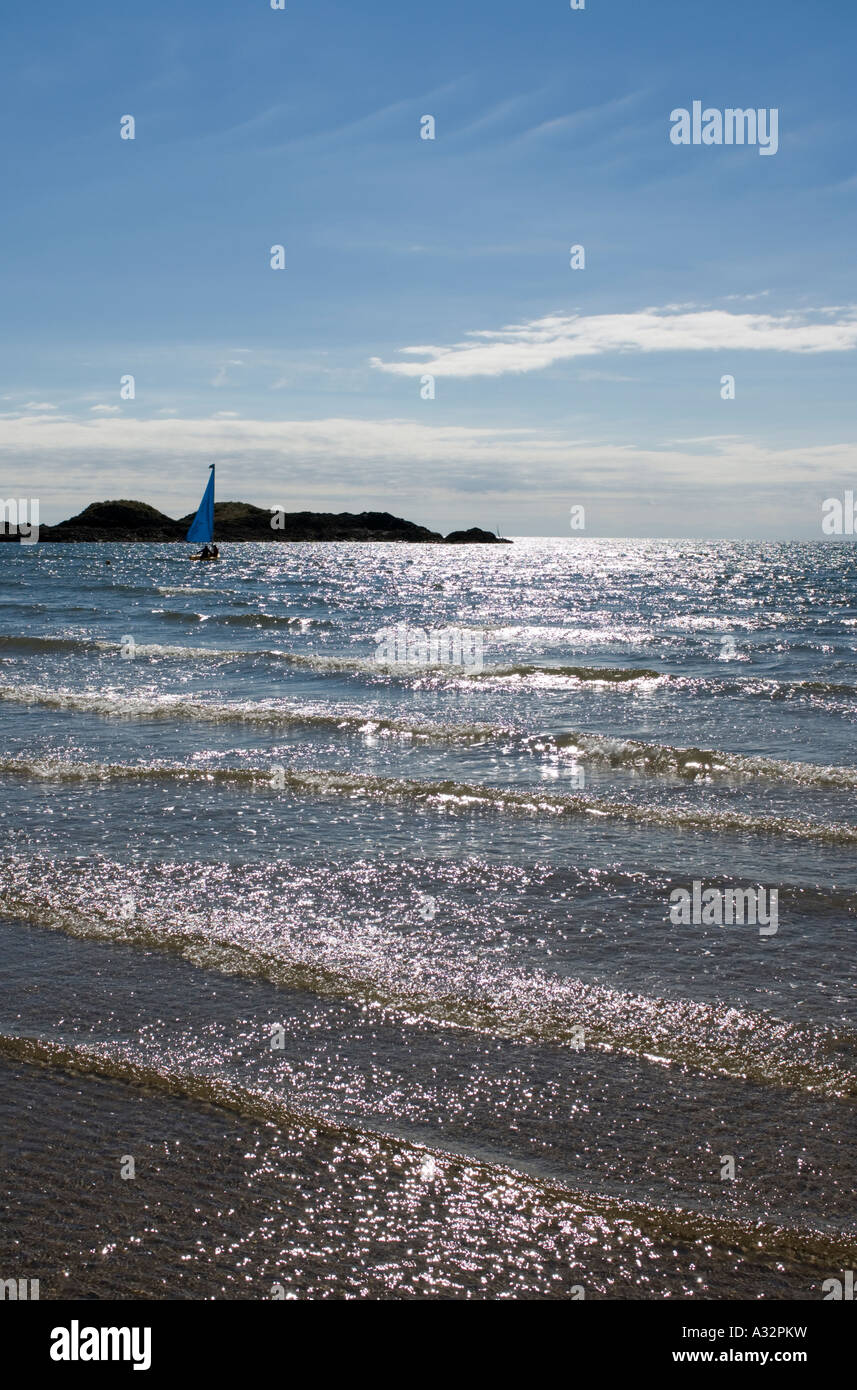 Sailing Boat with Rocks on the Horizon Stock Photo - Alamy