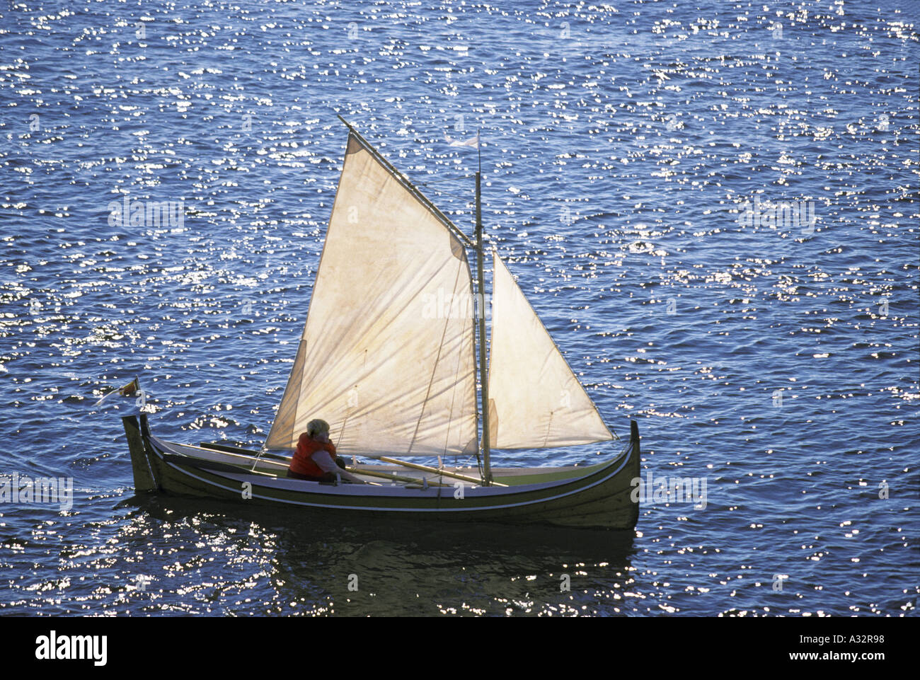 one man sailing boat in bronnoysund viwe from the coastal express ship  which sails between bergen and kirkenes Stock Photo - Alamy