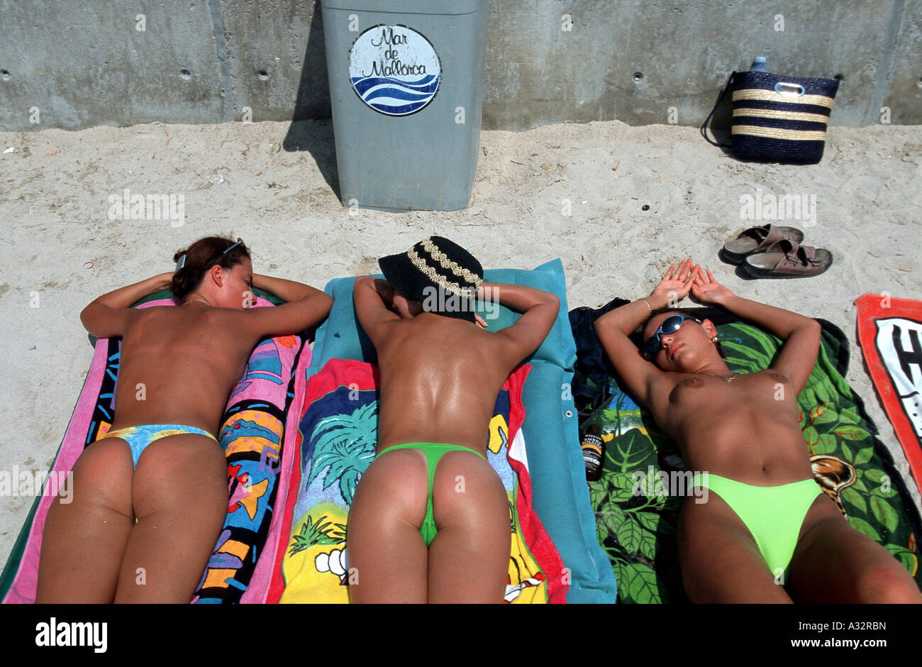 Young girls sunbathing on a beach on Mallorca, Spain Stock Photo - Alamy