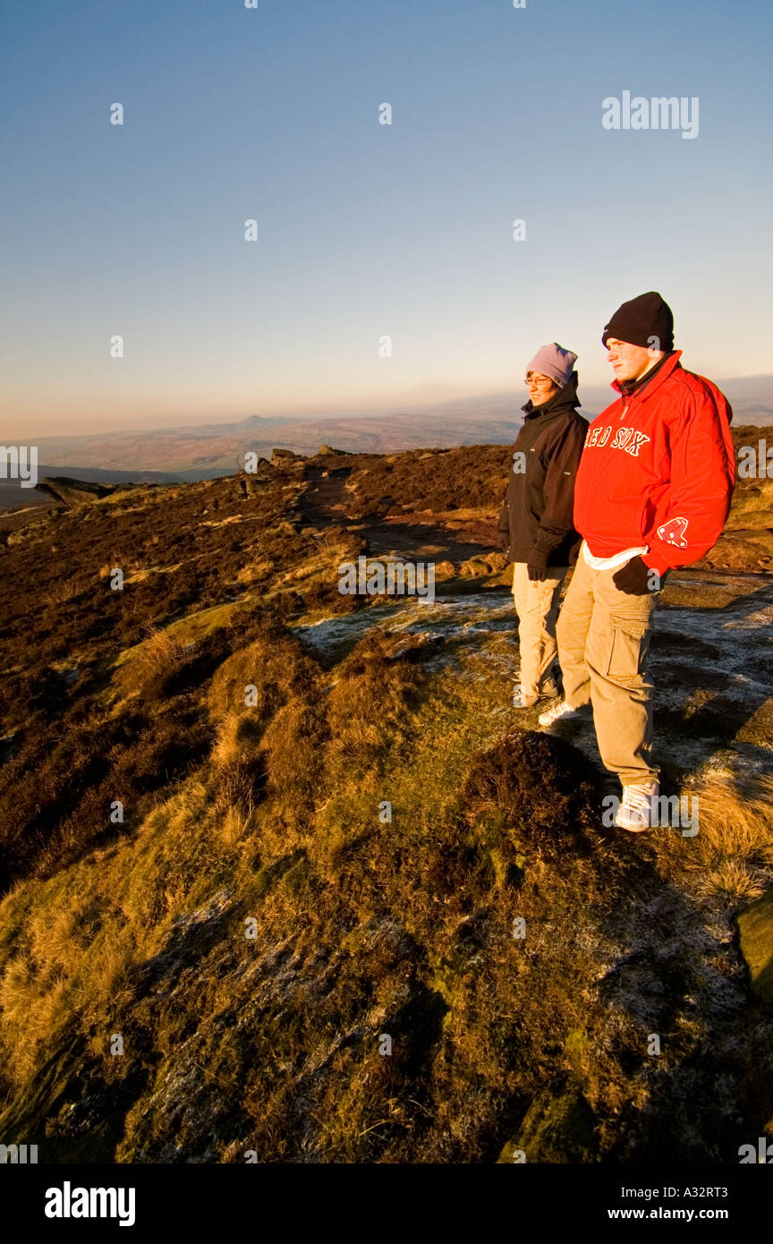 Girl and Teenage Boy Look out Across The Cheshire Plains in Winter Staffordshire UK Stock Photo