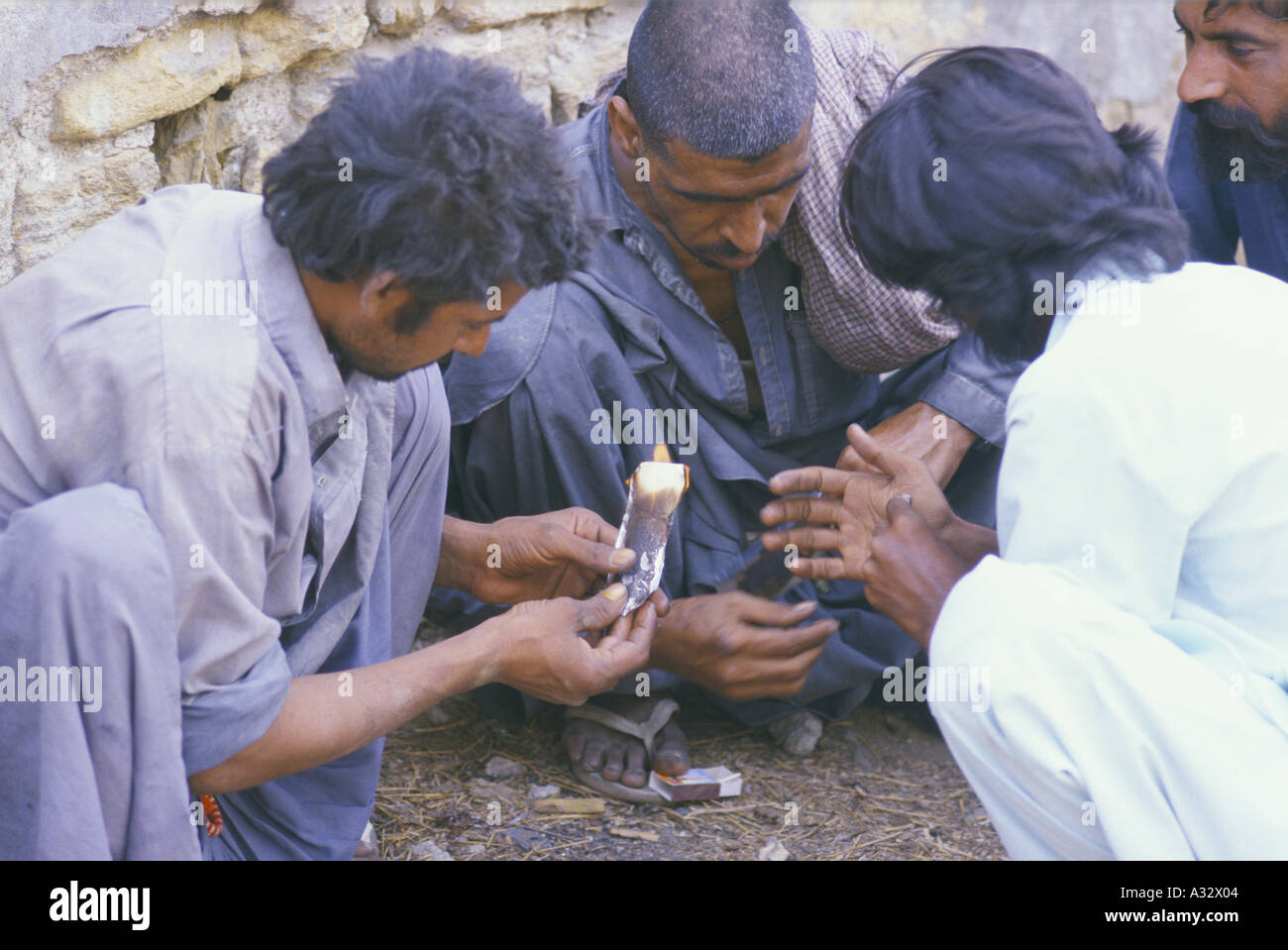 Men smoking heroin, Pakistan Stock Photo Alamy