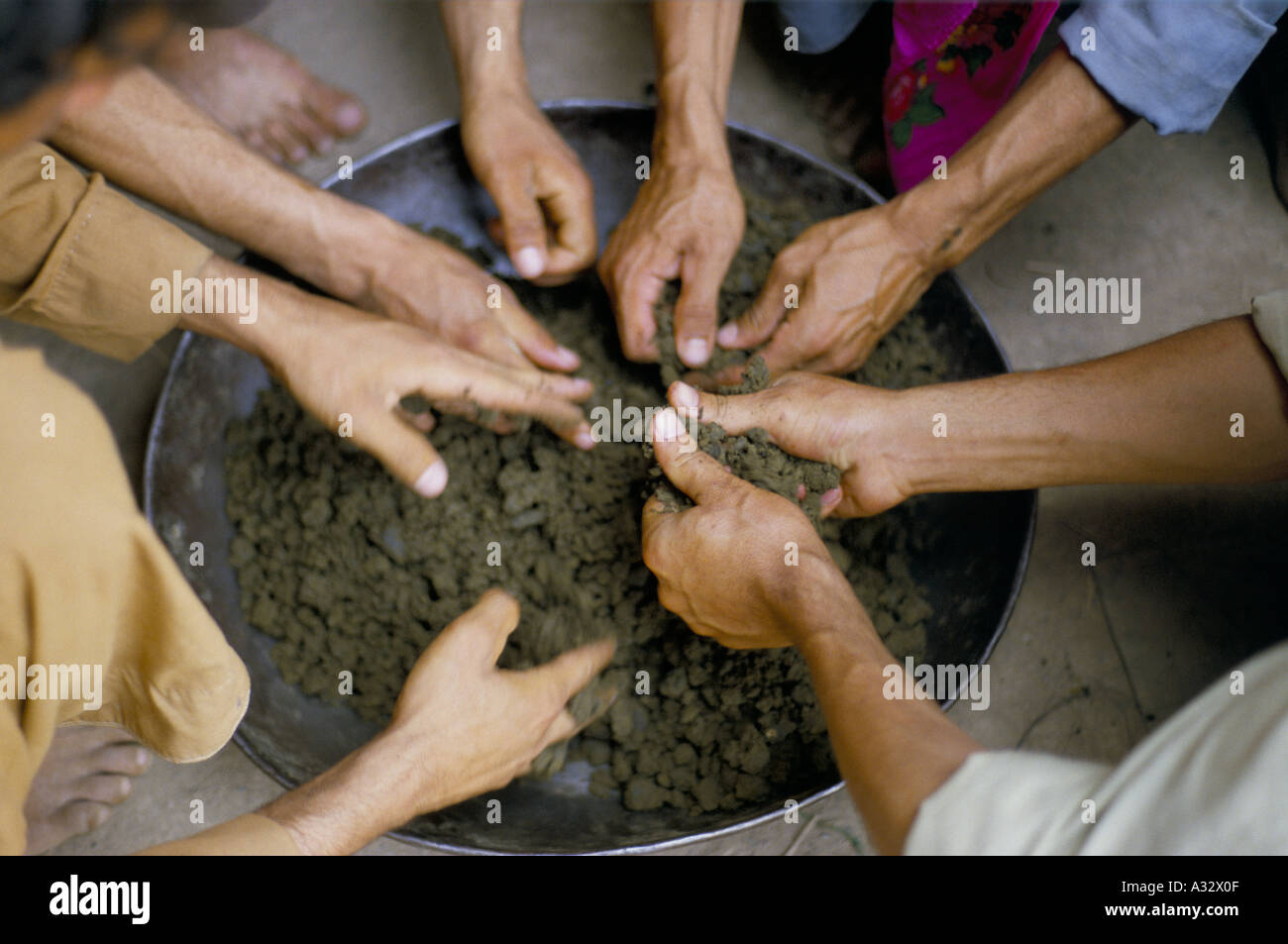 Cannabis resin: Hands kneading cannabis resin in a hash factory, North West Frontier Provence, Pakistan. Stock Photo