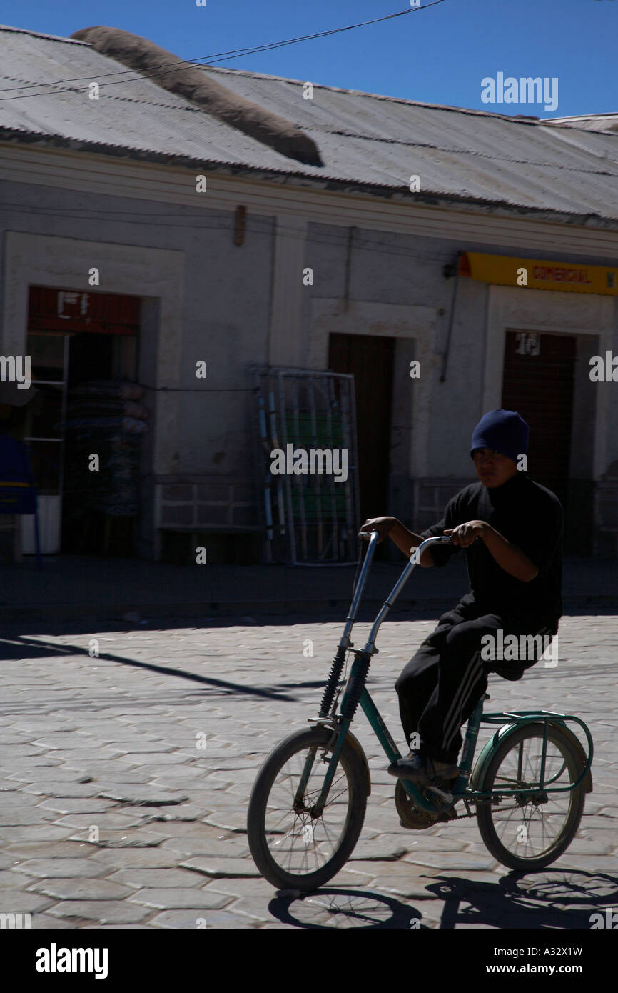 Bolivian boy on bike uyuni Stock Photo