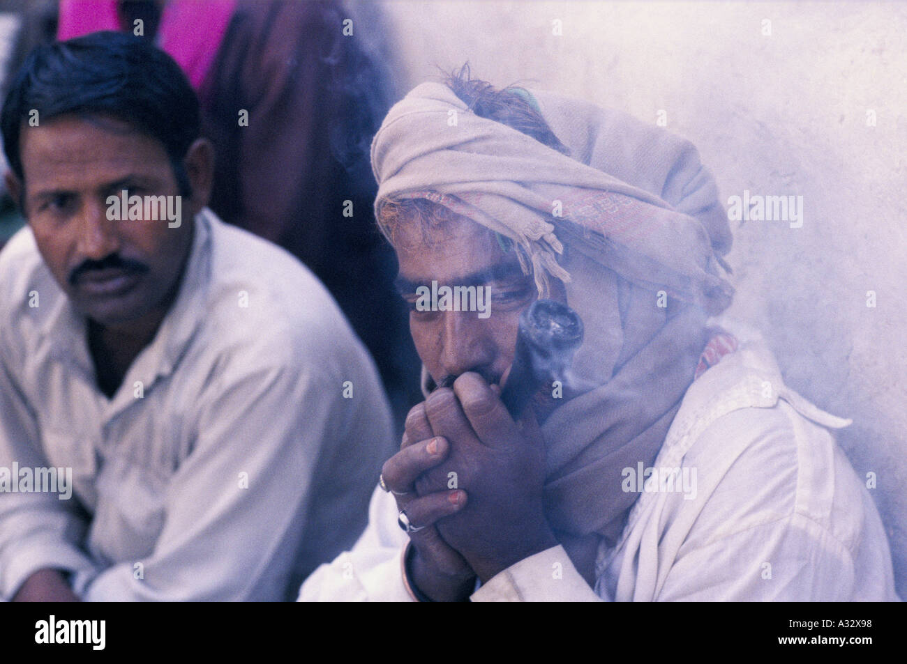 Put that in your pipe and smoke it, man smoking cannabis, Pakistan Stock Photo