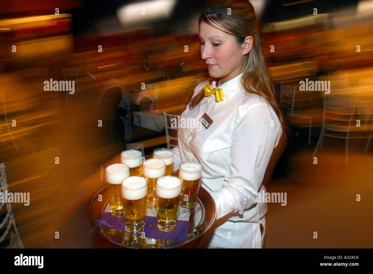 Waitress carrying a tray of beer glasses Stock Photo Alamy
