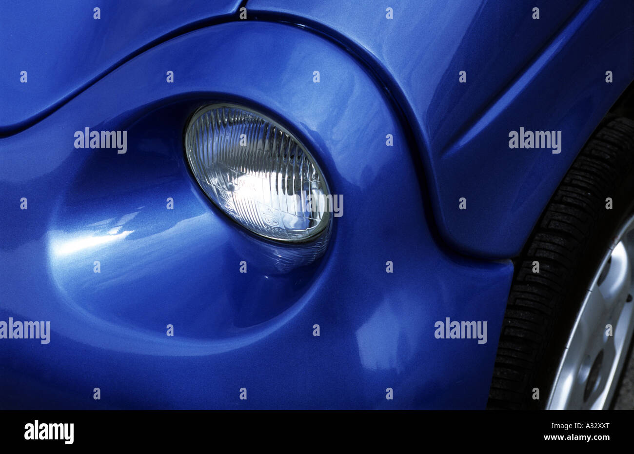 Headlight on a Reva G-Wiz electric car Stock Photo
