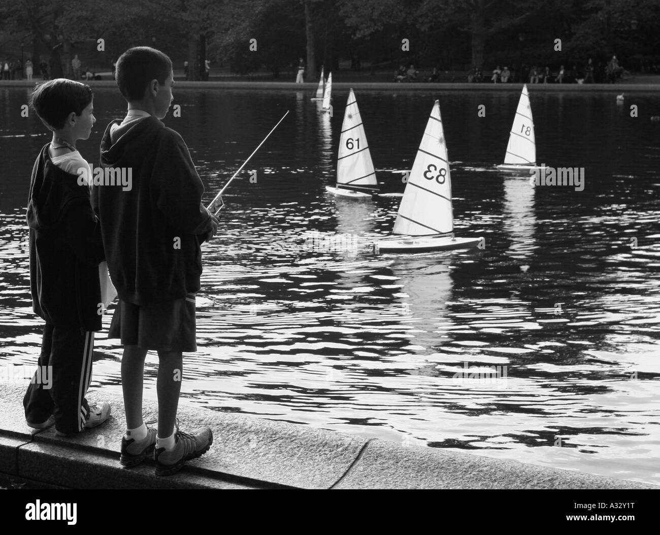 Kids with remote Sail boats Conservatory Water Central Park New York Stock Photo