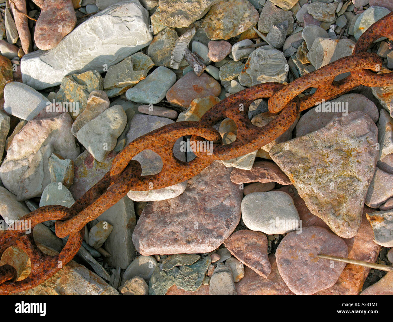 old rusty iron chain on stones Stock Photo