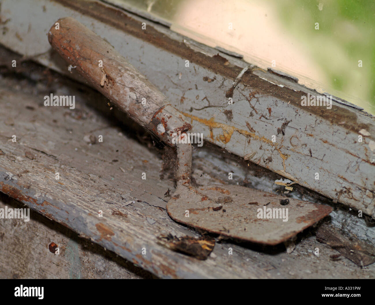 old tool spatula at an old decayed window Stock Photo - Alamy