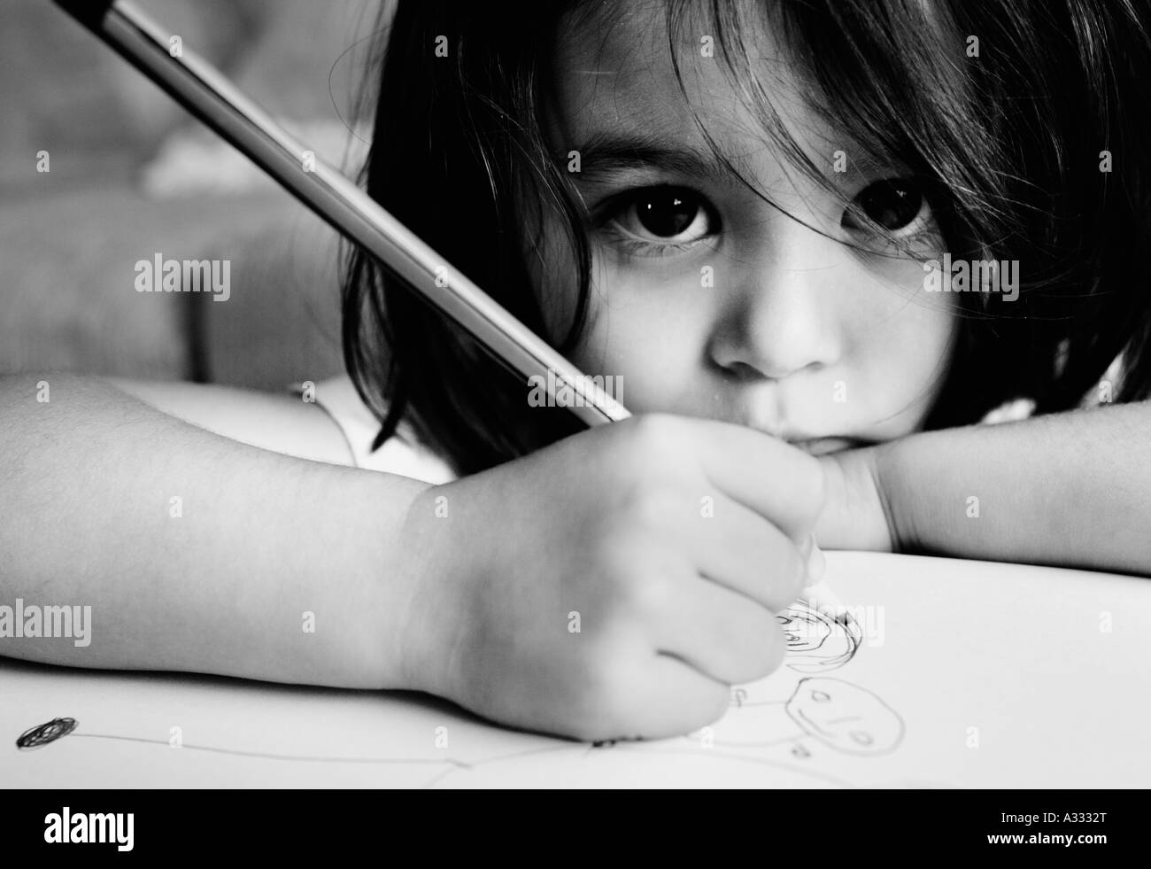 Pretty girl draws pictures with pencil and paper Stock Photo
