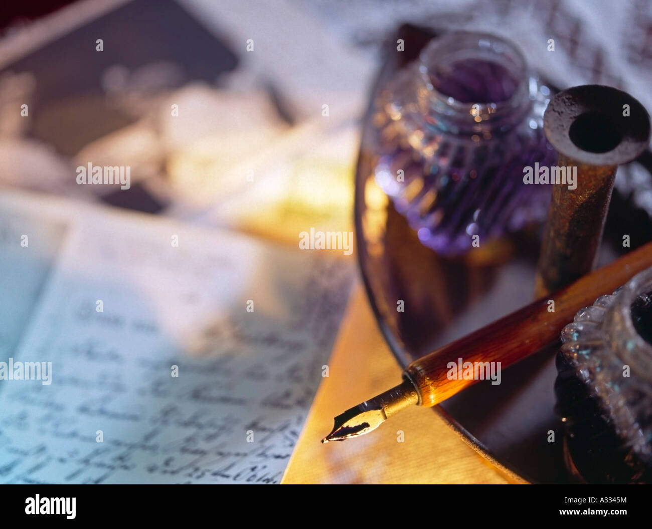 old nib pen with ink bottles beneath a letter with old script in