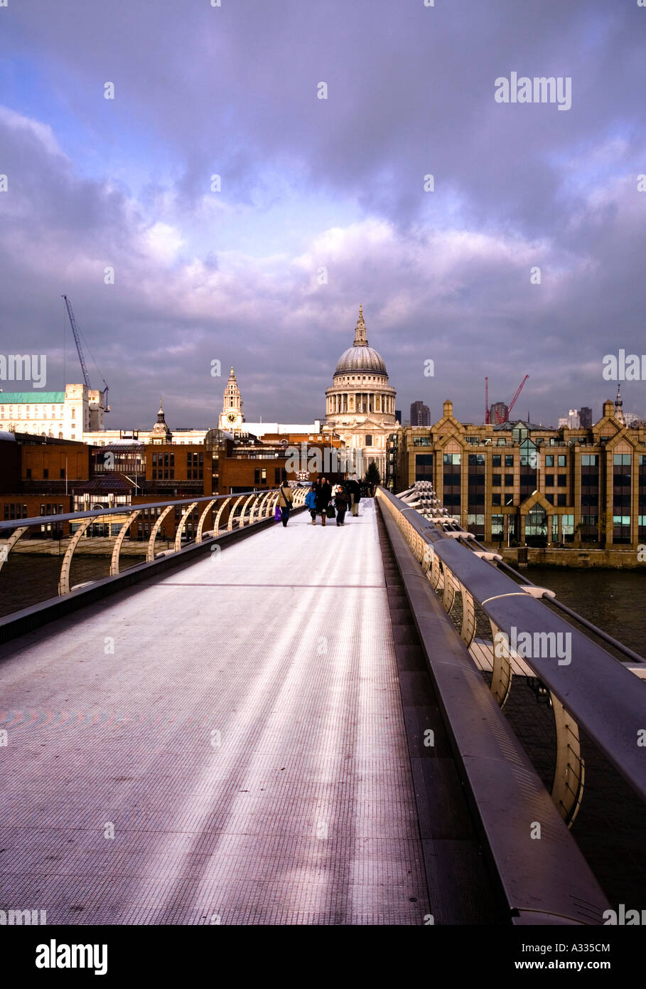 Stormy clouds over the millennium bridge with St.Paul's cathedral Stock Photo