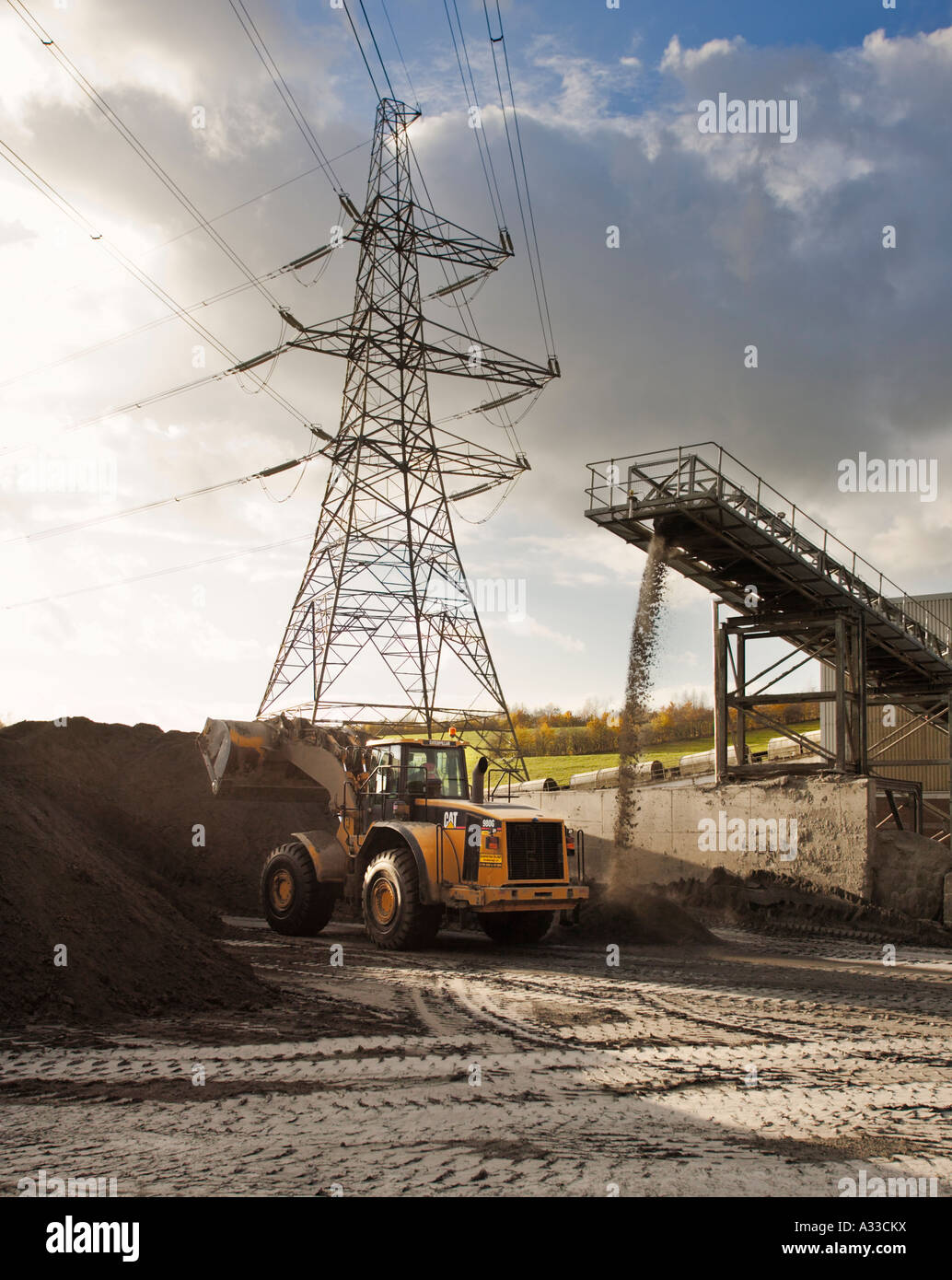 Tractor stacks up waste ash for disposal at coal ^fired power station uk Stock Photo