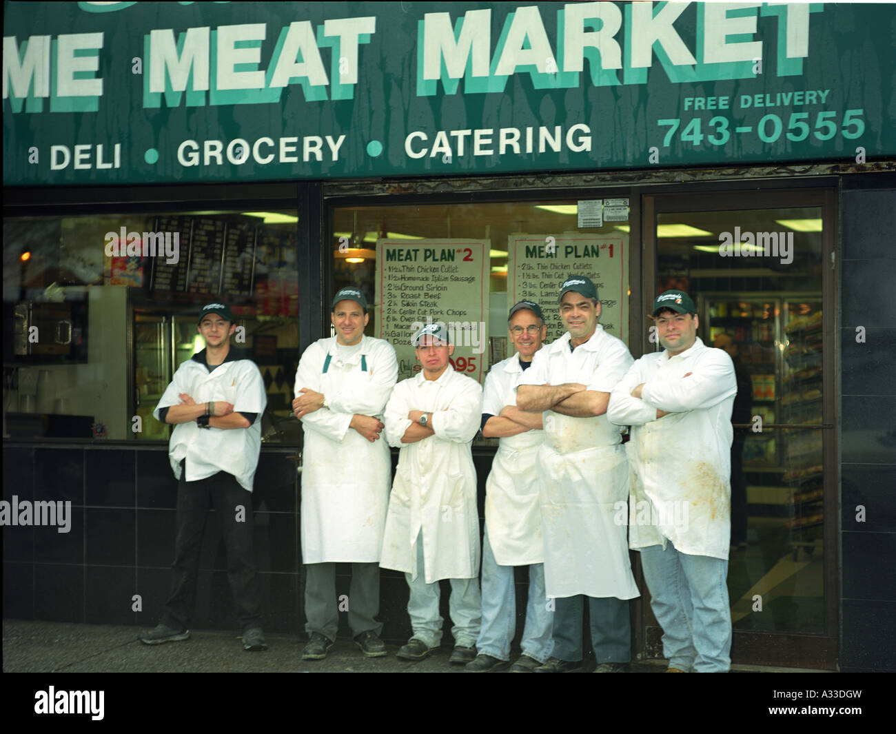 family of meat market, generations of workers standing outside thier