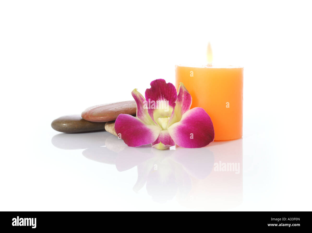 Candle River Stones and Pink Petals with Inverted Reflection Stock
