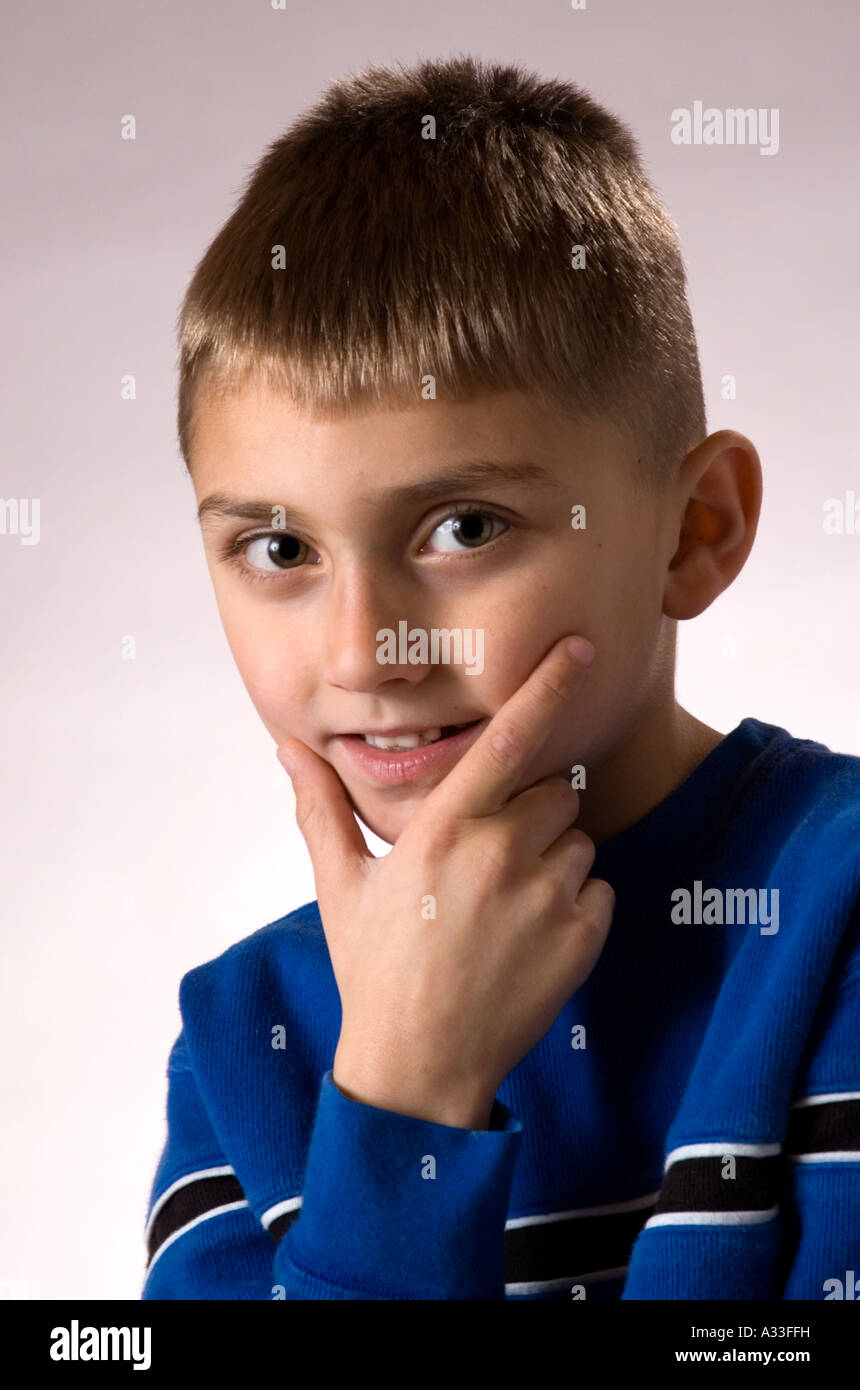 6 year old boy poses for camera in an informal portrait setting Stock Photo Alamy