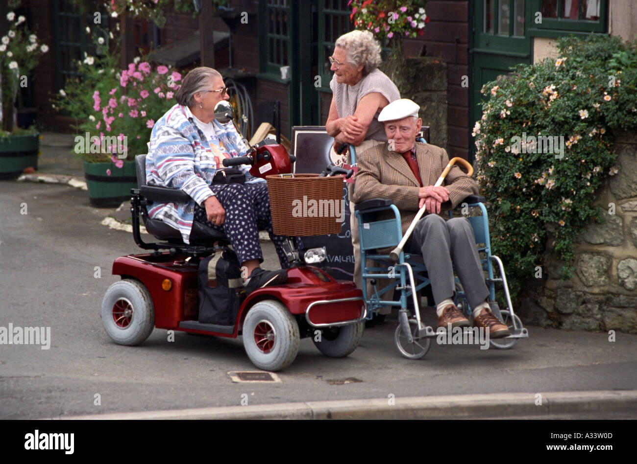 old disabled pensioners chatting outside house Isle of Wight UK England