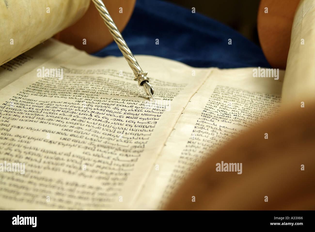 Hebrew Torah scroll with silver yad pointing to Hebrew words Stock Photo
