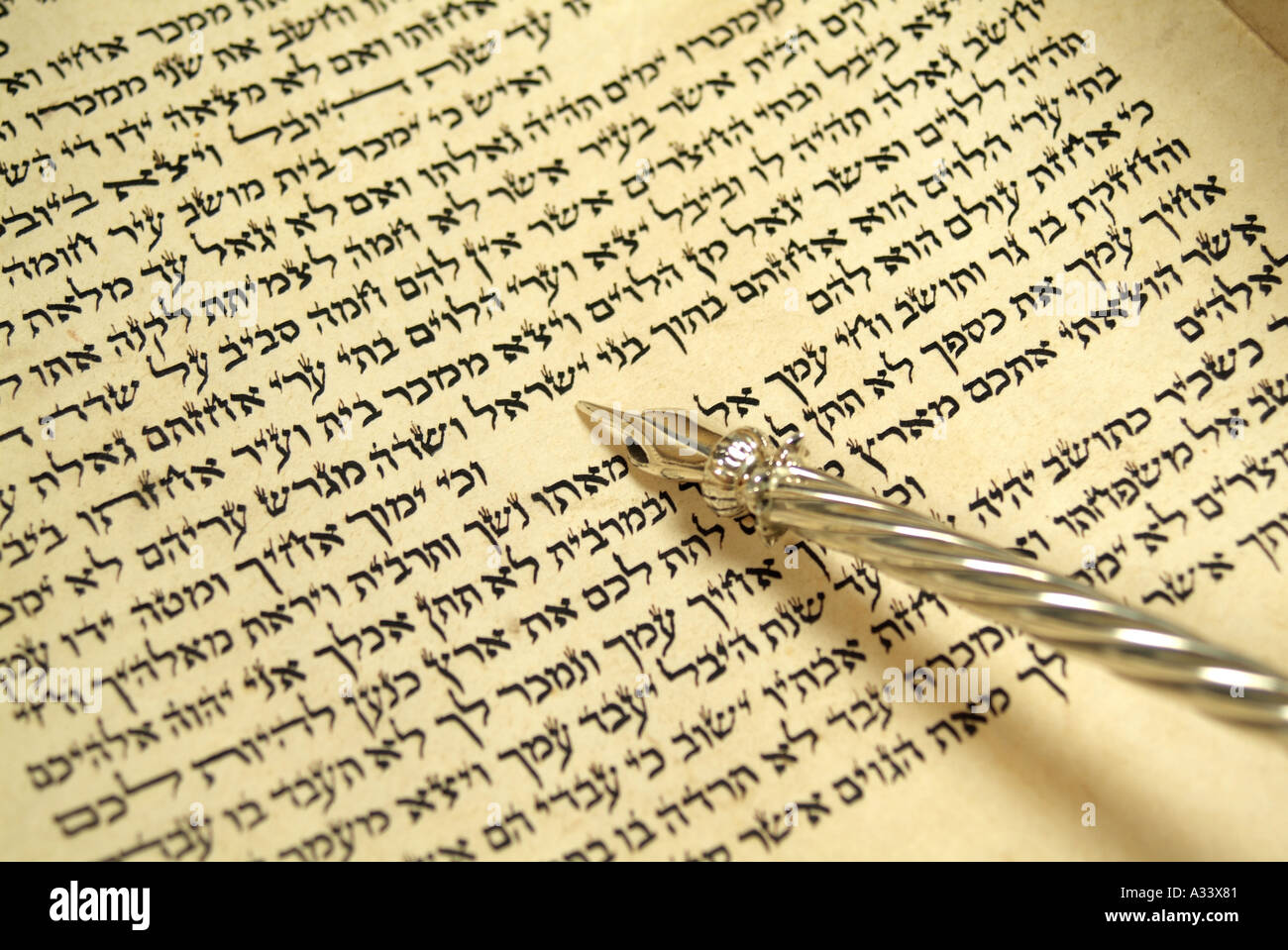 Hebrew Torah scroll with silver yad pointing to script Stock Photo
