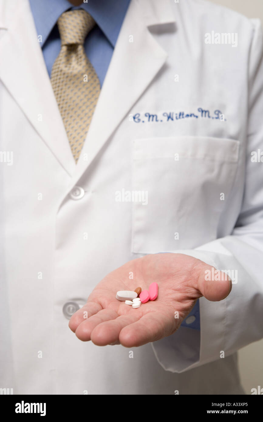 Doctor holding drugs in hand Stock Photo Alamy