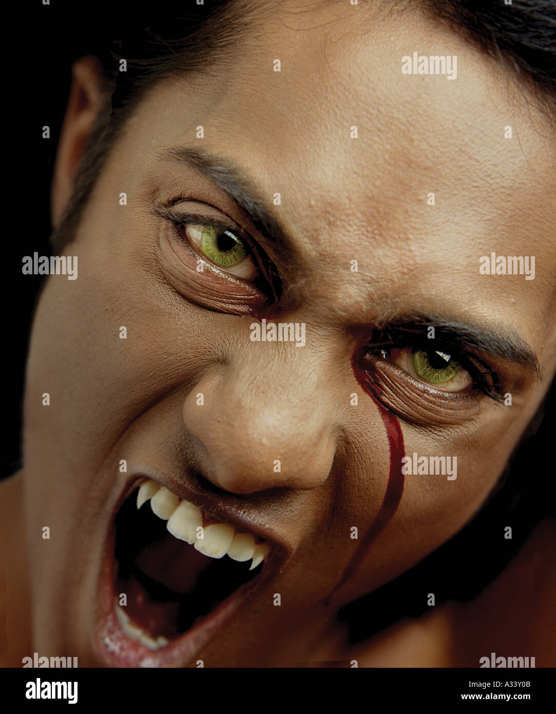 Vampire bleeding from right eye in blood Stock Photo
