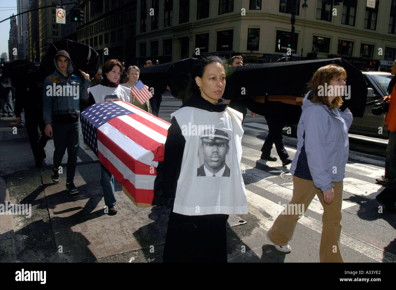 Several hundred members of the War Resisters League and their supporters march with flag draped and black cloth covered coffins on March 19 2005 from the United Nations to the Military Recruiting Station in Times Sqaure The march culminated with an act of civil disobedience by about thirty members of the group The protest was on the second anniversary of the United States invasion of Iraq Richard B Levine Stock Photo