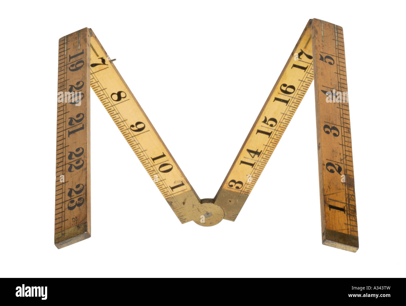 Folding wood measuring ruler Brass hinges Letter M Stock Photo