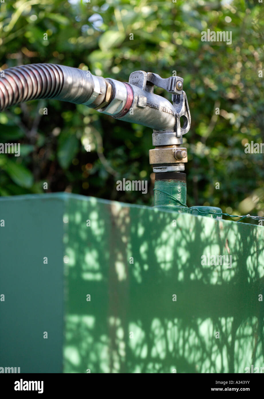 Household heating oil tank being filled by pump Stock Photo