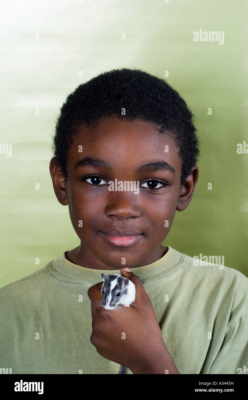 young boy holding his gerbil Stock Photo