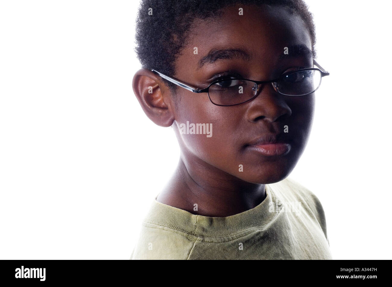 Portrait of an 8 years black child looking at camera against a white background Stock Photo