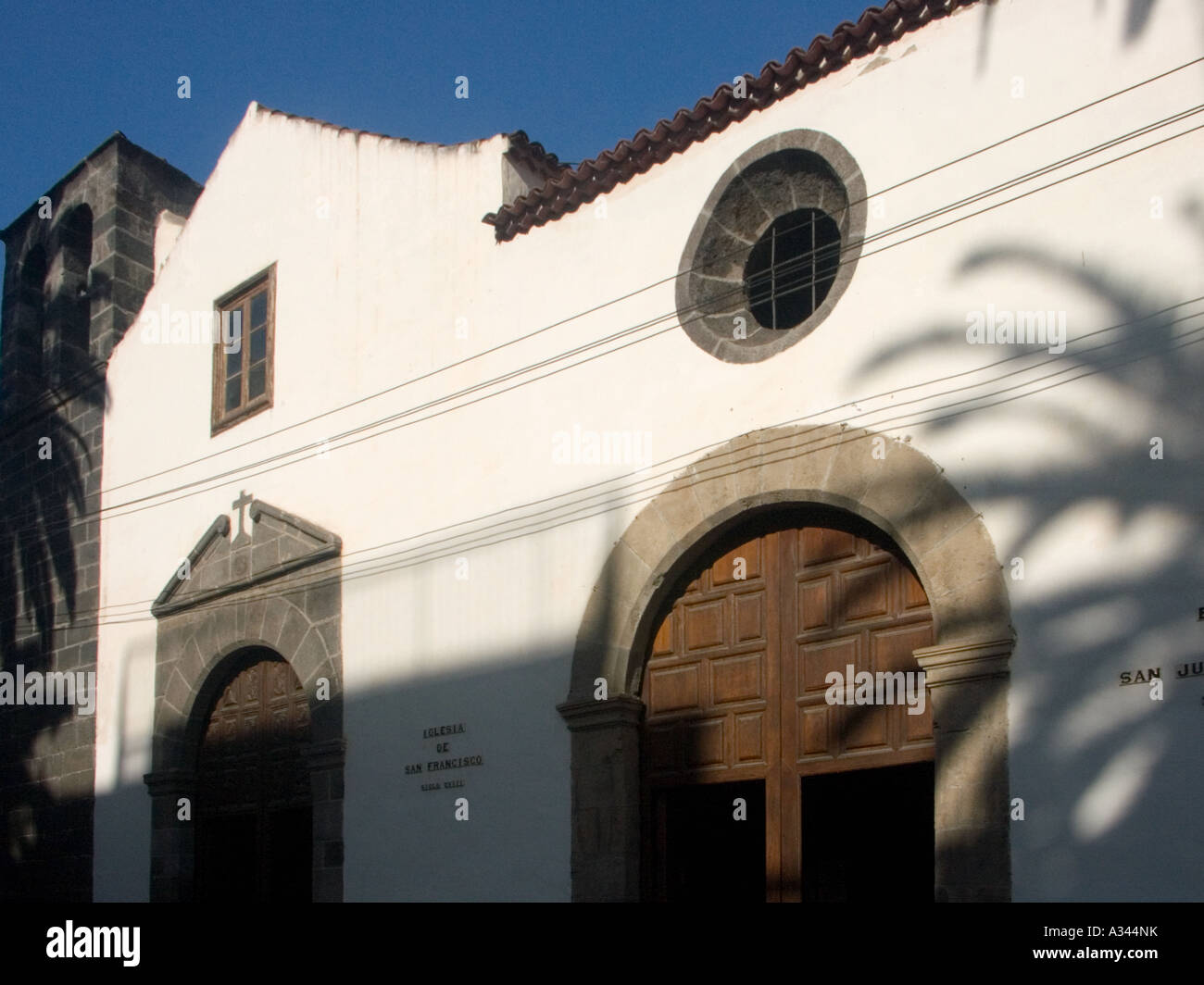 Iglesia de San Francisco and Ermita de Juan Bautista with palm tree ...