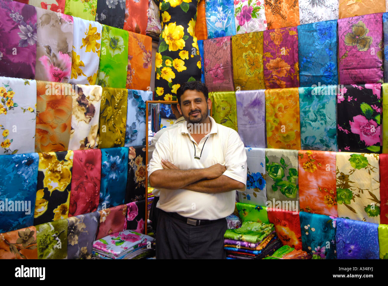 Pakistani small business owner textile merchant in his store, Stock Photo