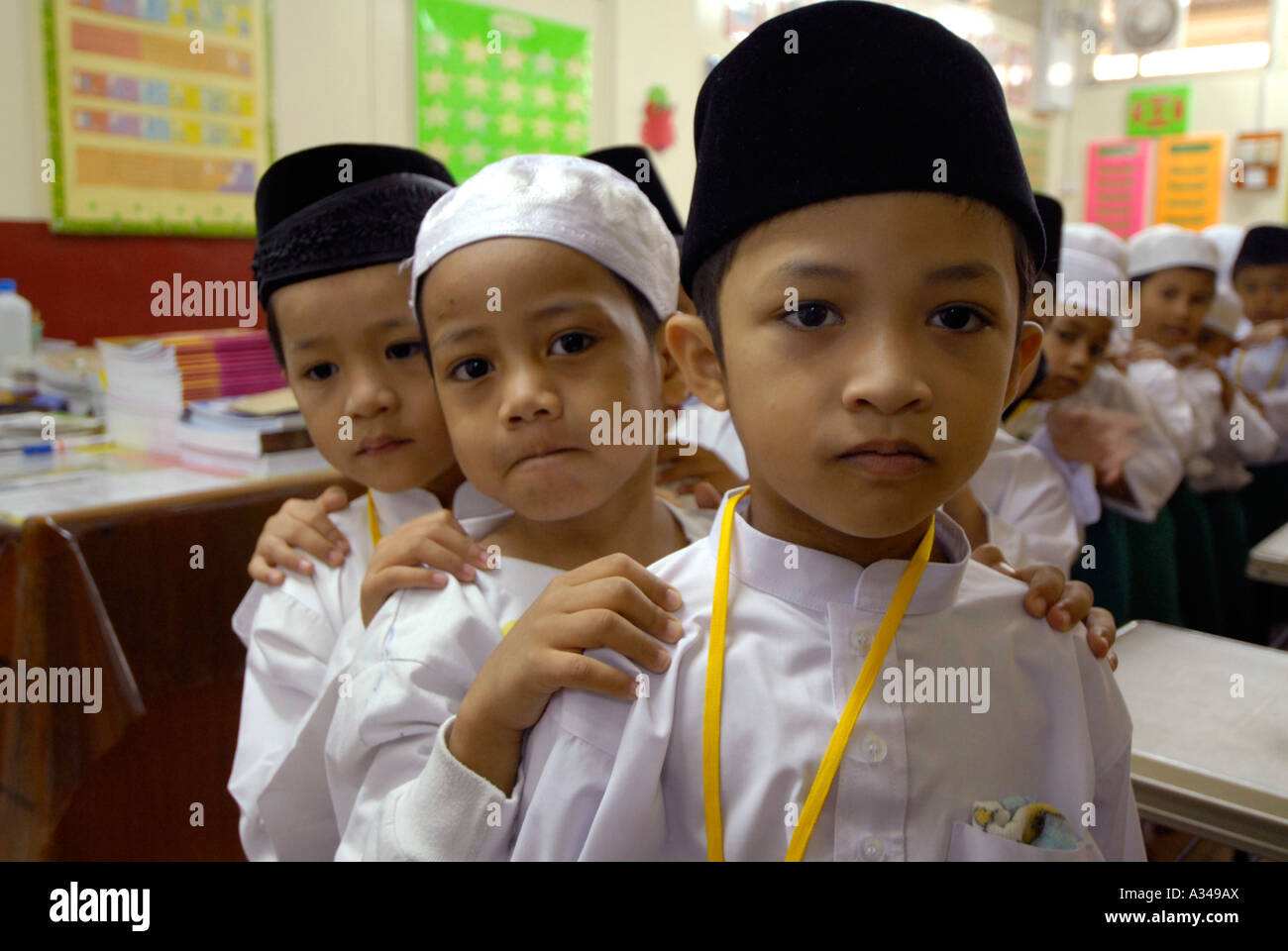 Primary level one and kindergarten students lining up for prayer time at a Muslim  school, Kuala Lumpur, Malaysia Stock Photo