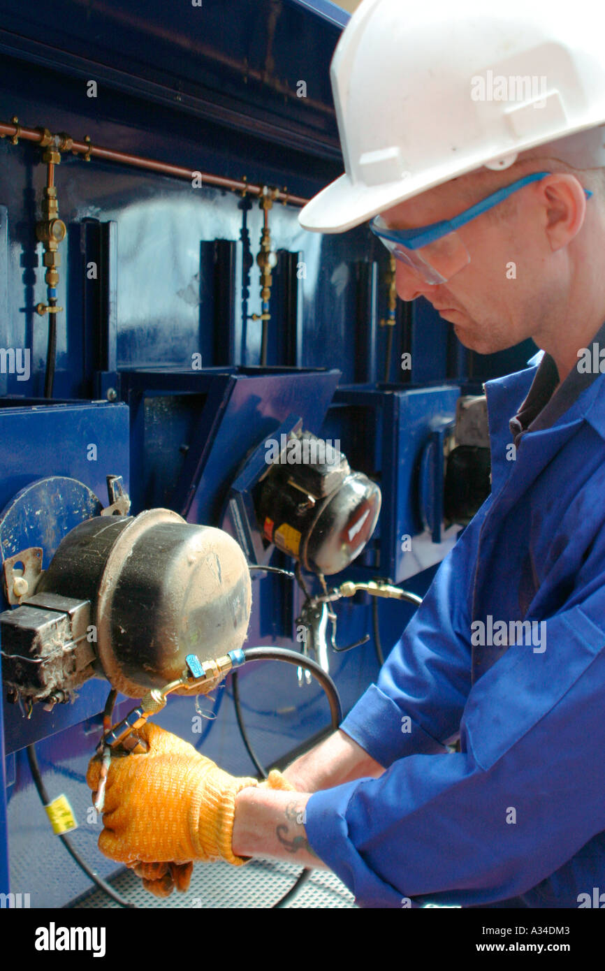 Cannisters being degassed at refrigerator and freezer recycling plant
