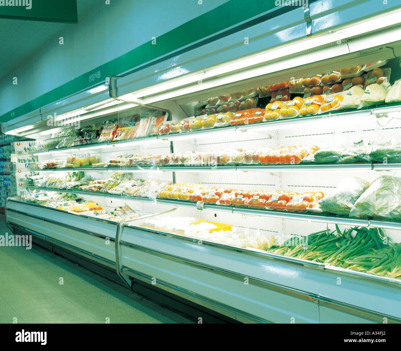 Fresh fruits and vegetables arranged on the display refrigerator Stock