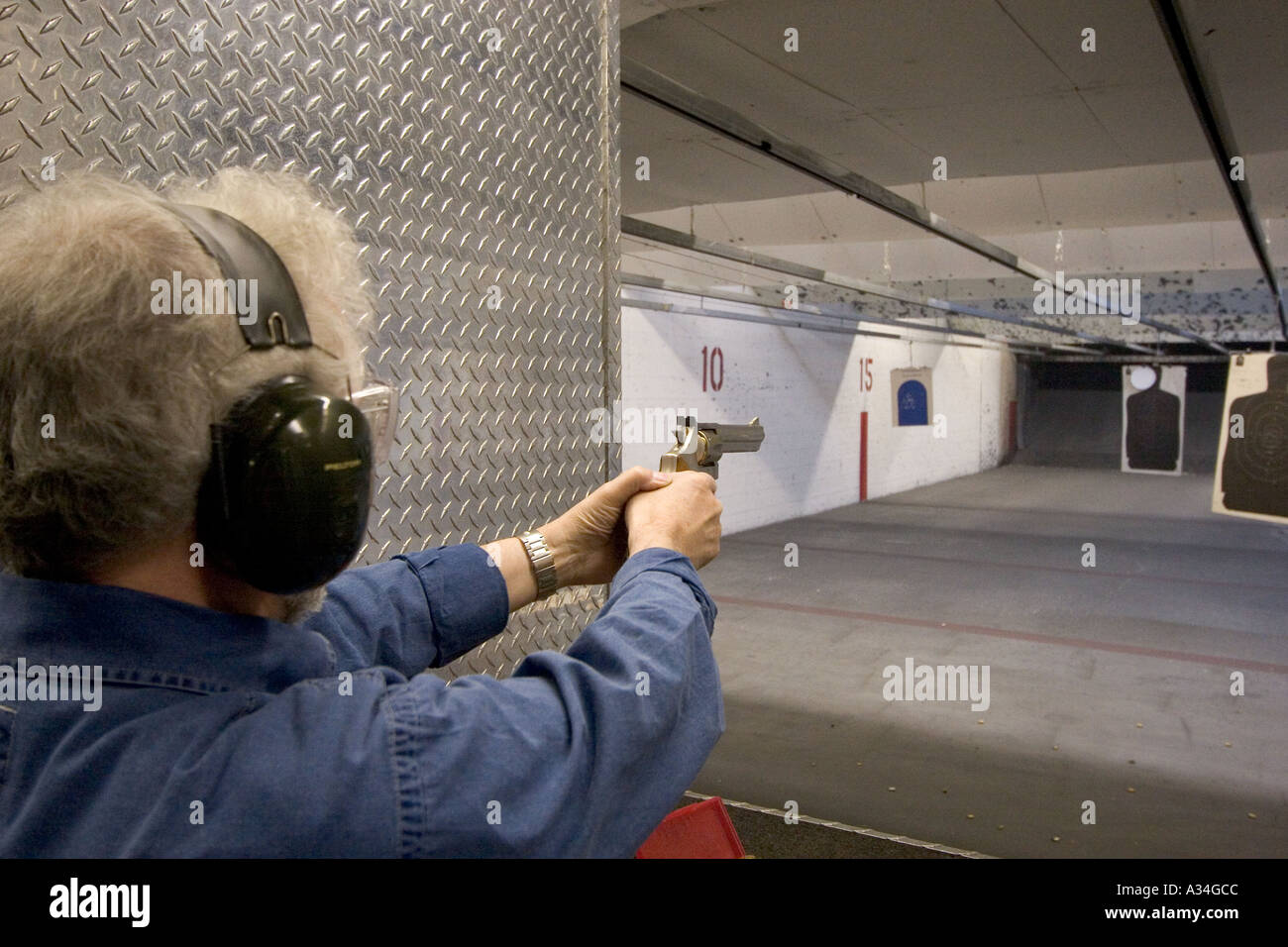 American indoor gun shooting range Male shooter at target practice Las