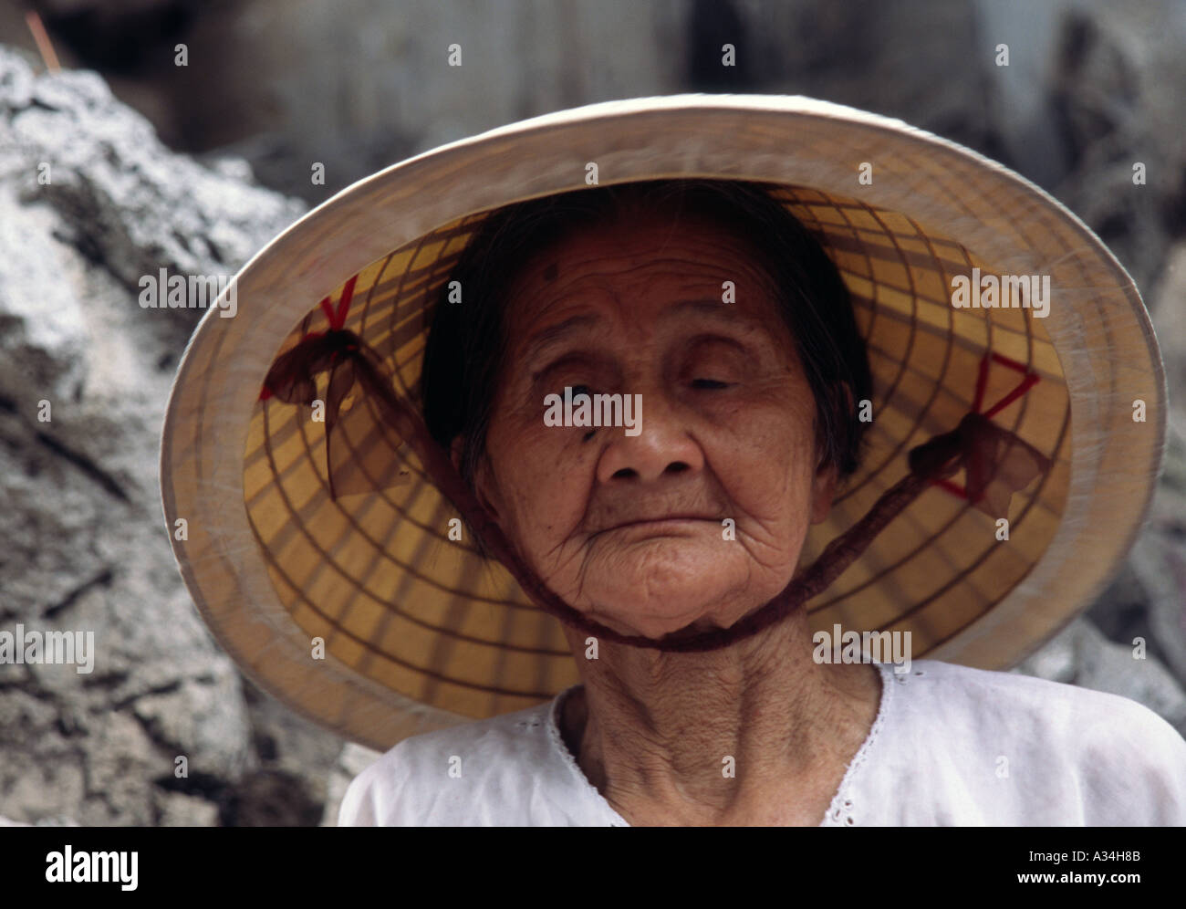 Elderly Vietnamese lady wearing a traditional hat Hanoi Vietnam Stock Photo