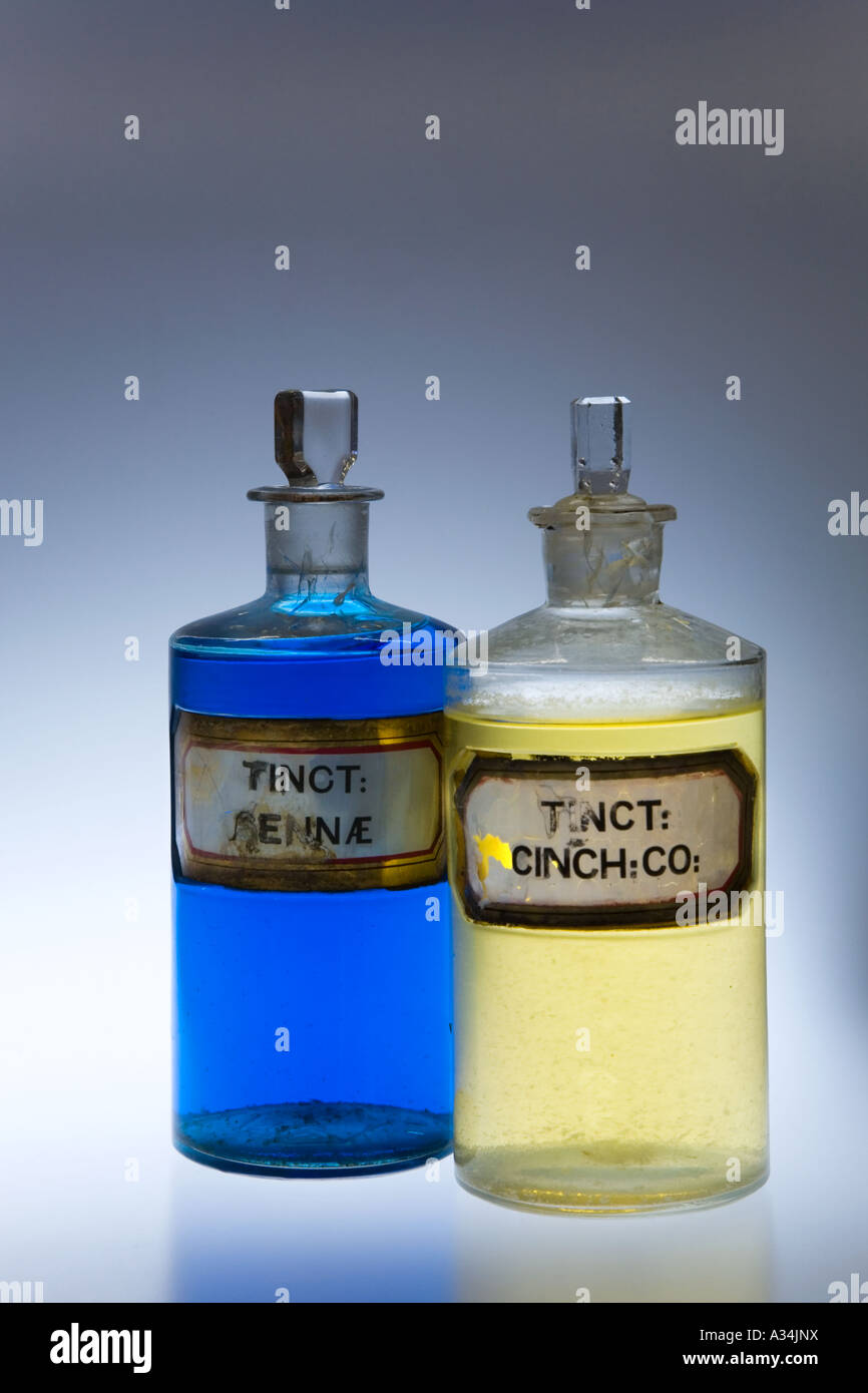 Coloured Liquid in Chemists glass;  stoppered Pharmacy Bottles; Apothecary, tincture, solution, medicine jars Victorian stock solutions of chemicals. Stock Photo