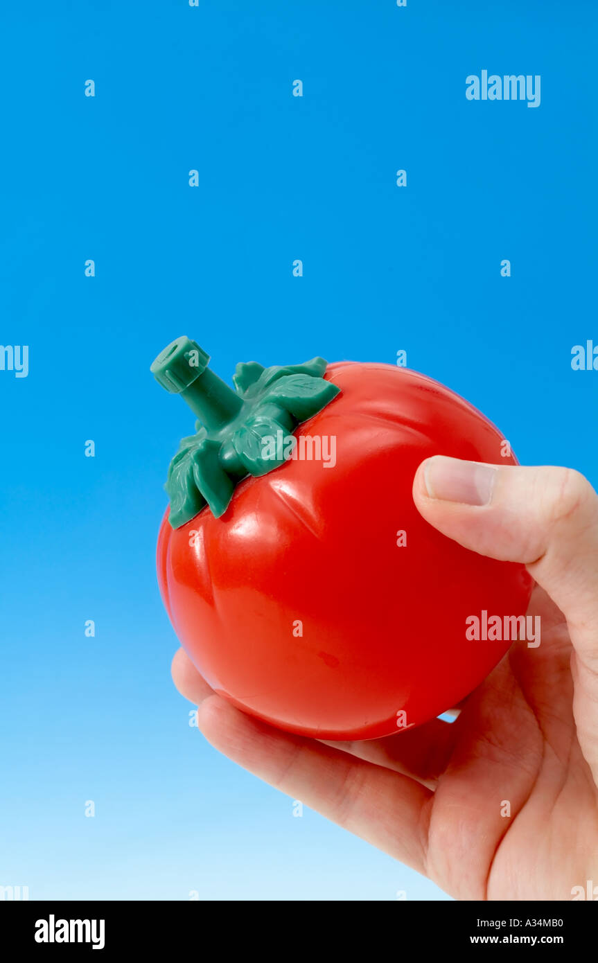 Hand squeezing tomato ketchup bottle Stock Photo Alamy