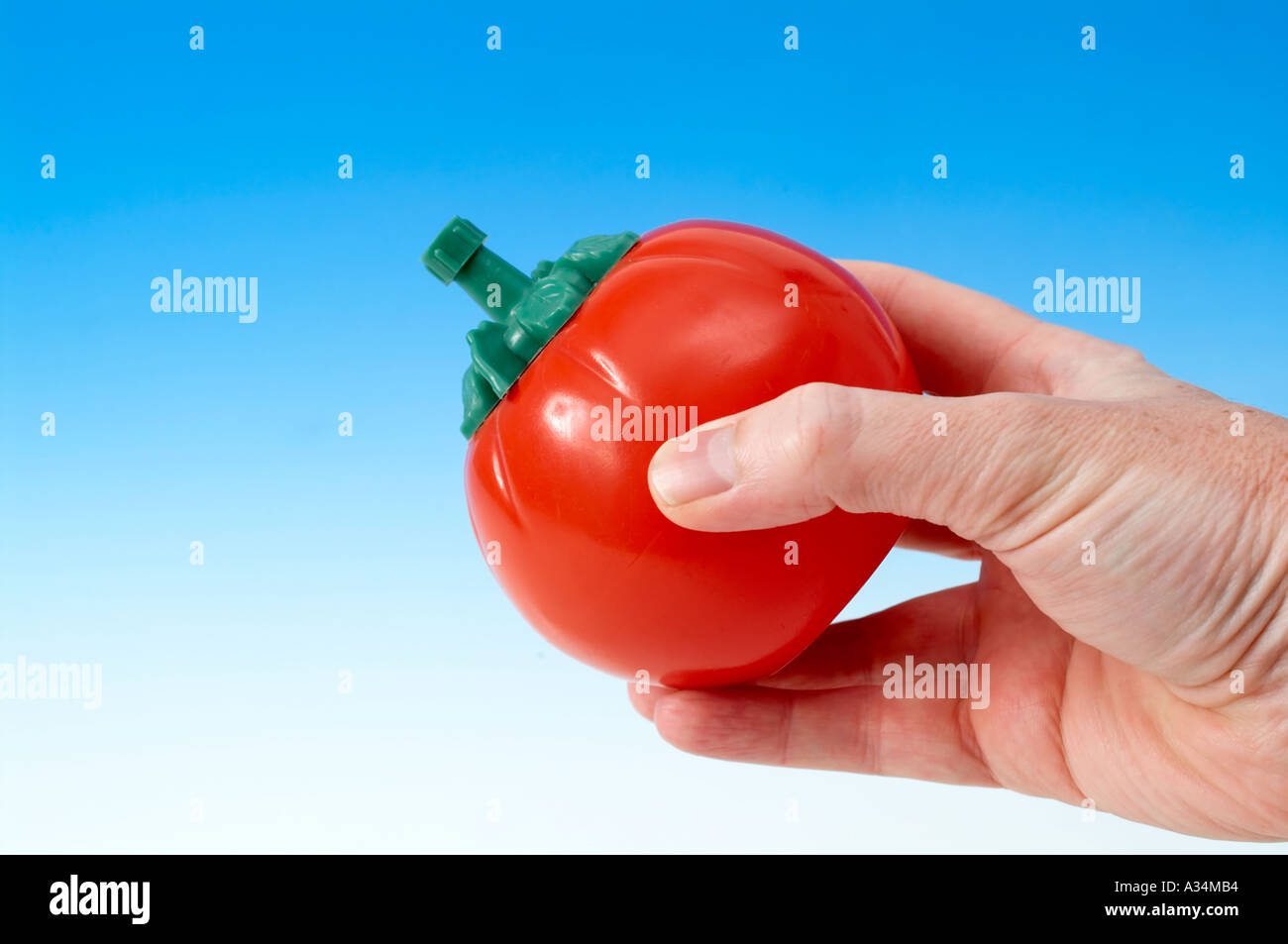 Hand squeezing tomato ketchup bottle Stock Photo Alamy