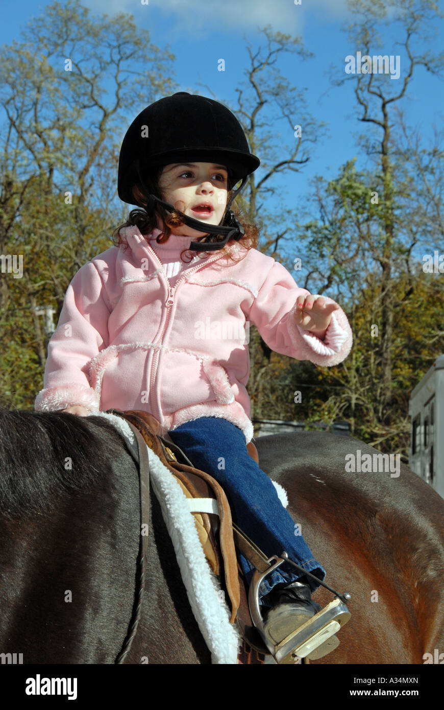 Three year old girl riding a horse Stanhope Stables Huntington NY Stock