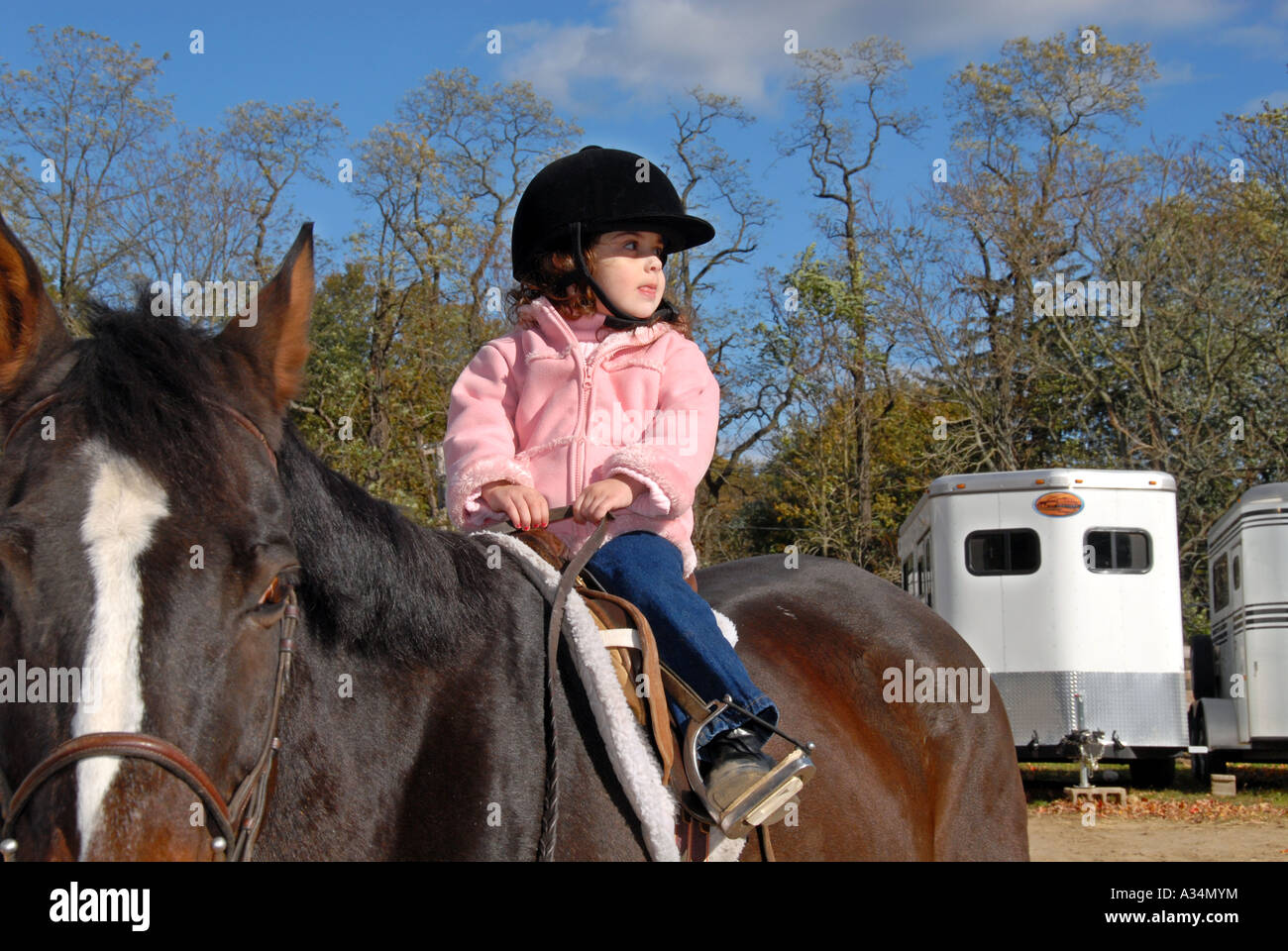 Three year old girl riding a horse Stanhope Stables Huntington NY Stock