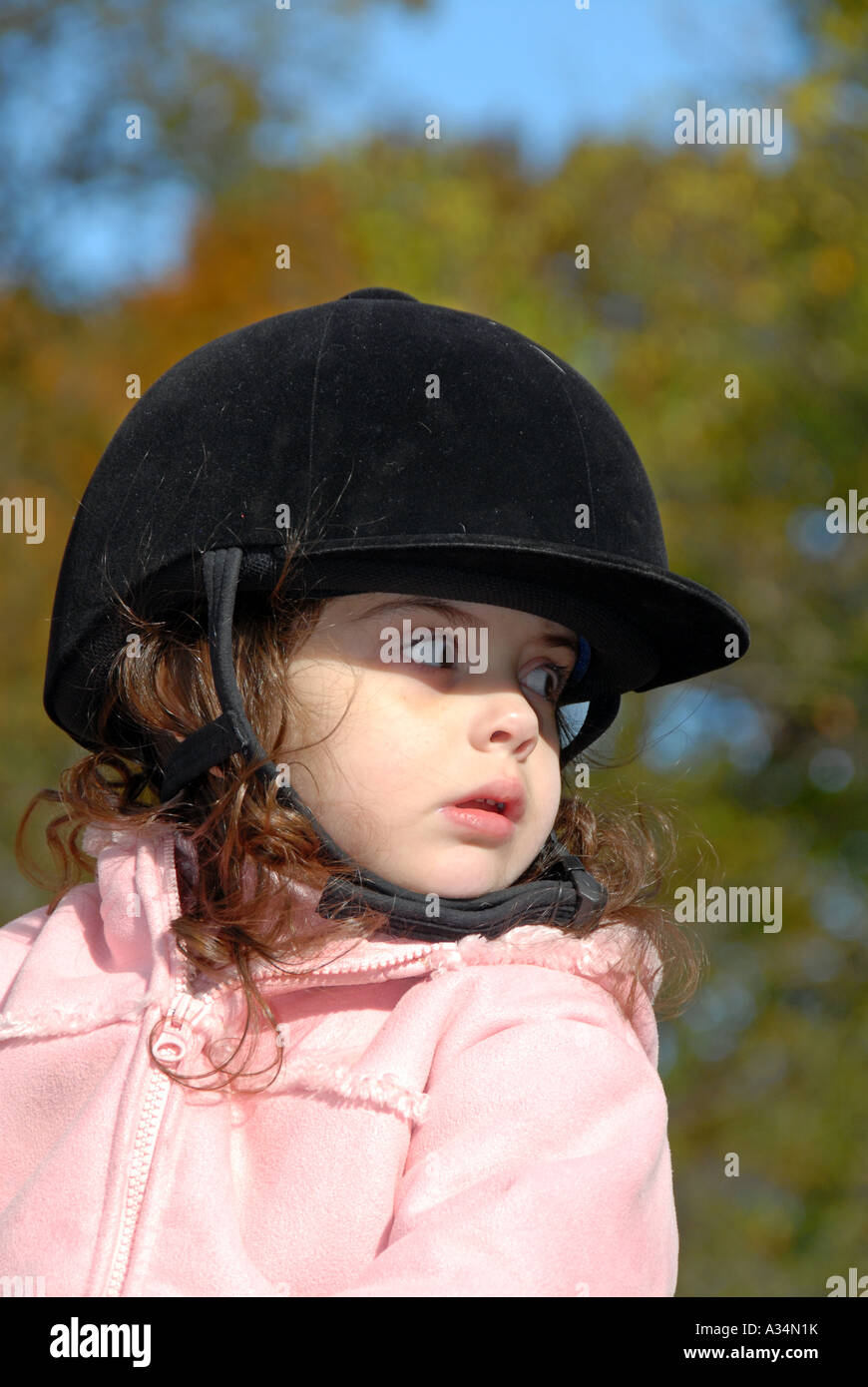 Three year old girl riding on a horse Stock Photo Alamy