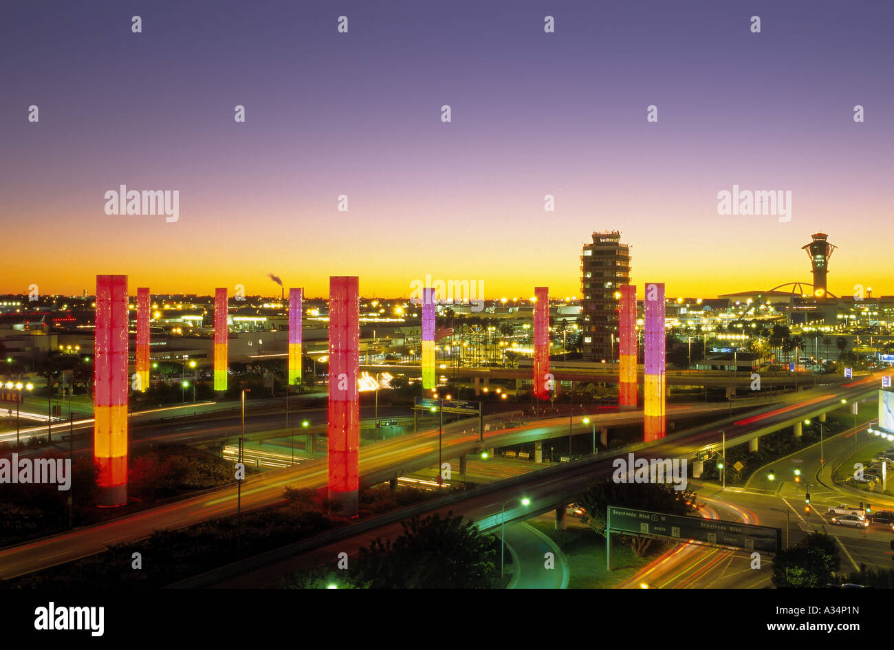 Colorful illuminated pylons form a decorative sight where Century Boulevard reaches Los Angeles International Airport, LAX Stock Photo