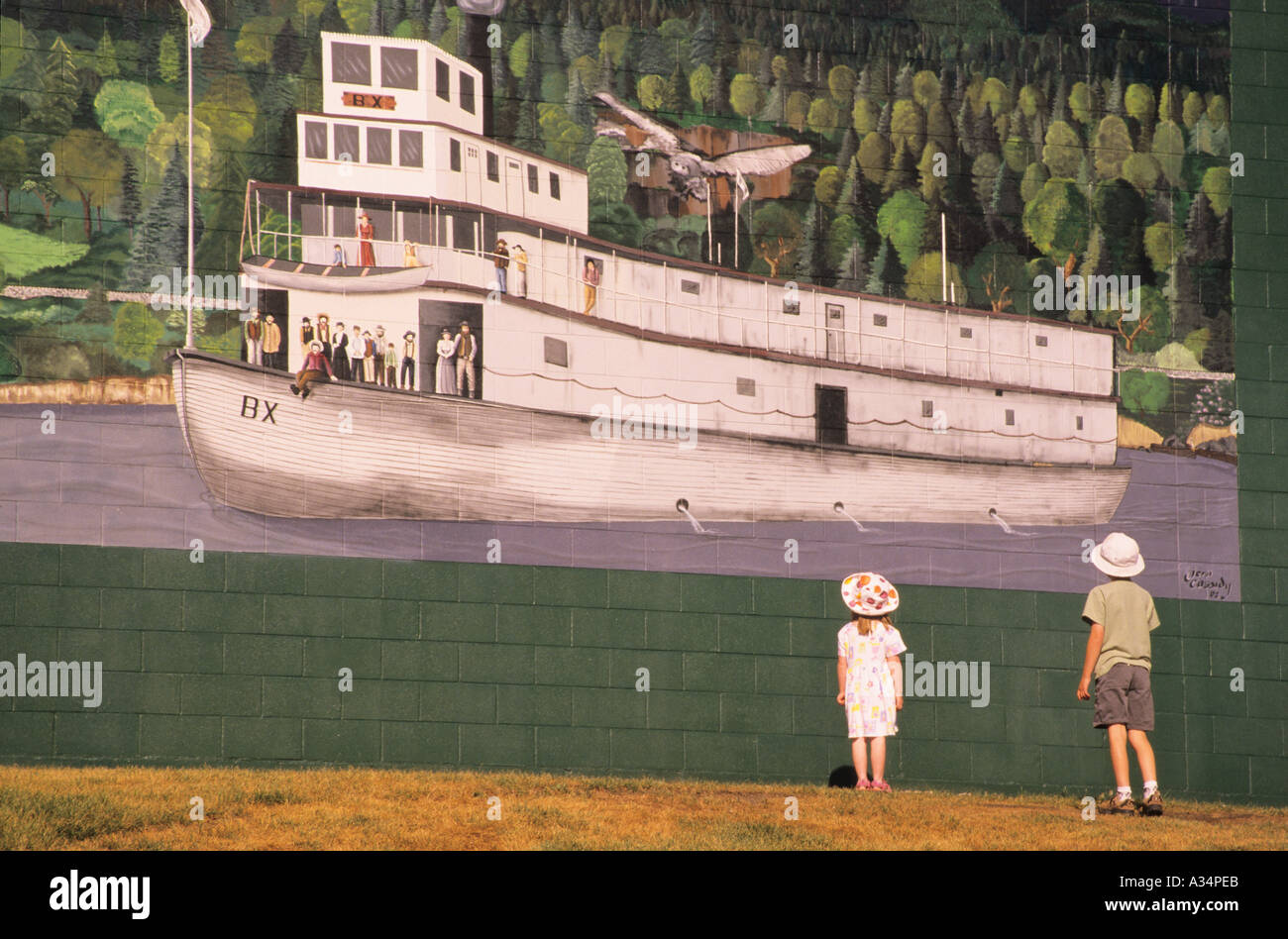 Children looking at historic mural Quesnel BC Canada Stock Photo