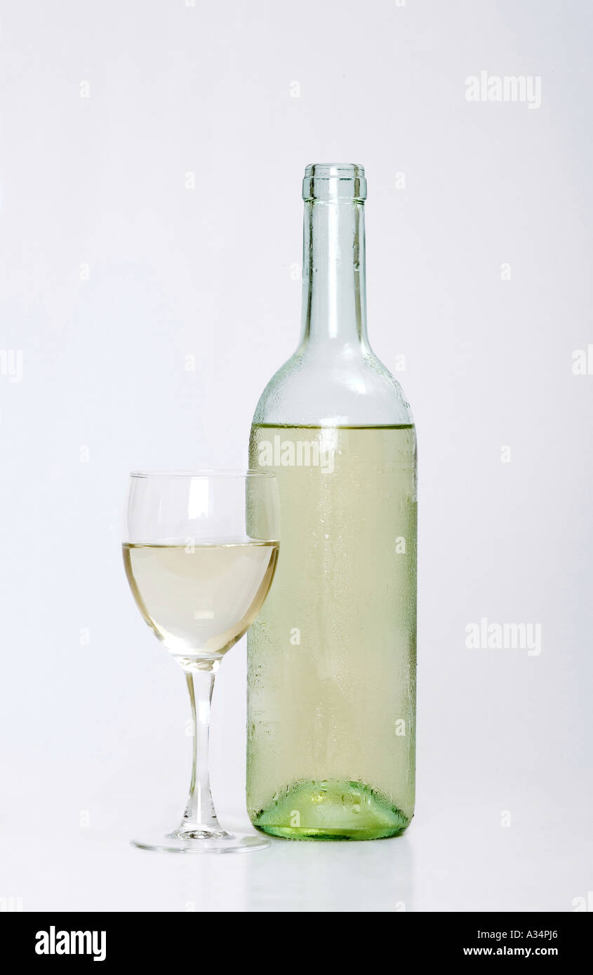 White wine bottle with half filled glass next to it with white isolated