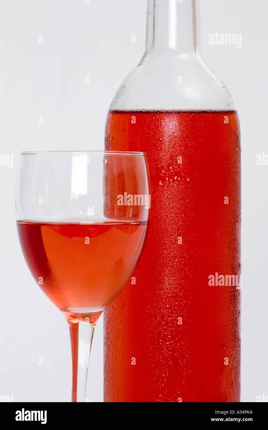 Glass of rose wine with bottle behind and white isolated background Stock Photo Alamy