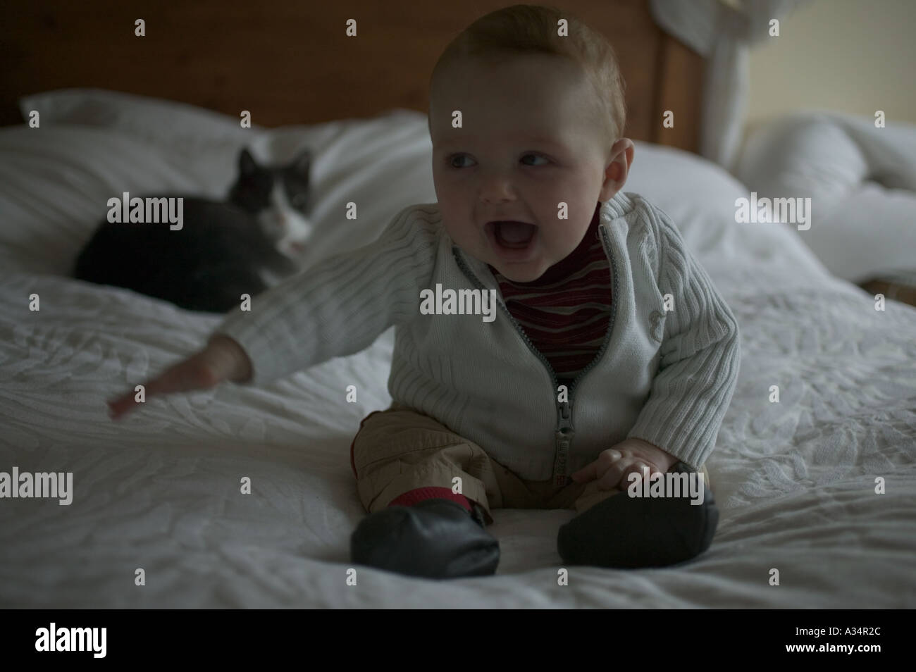 Curious baby boy sitting on bed hi-res stock photography and images - Alamy
