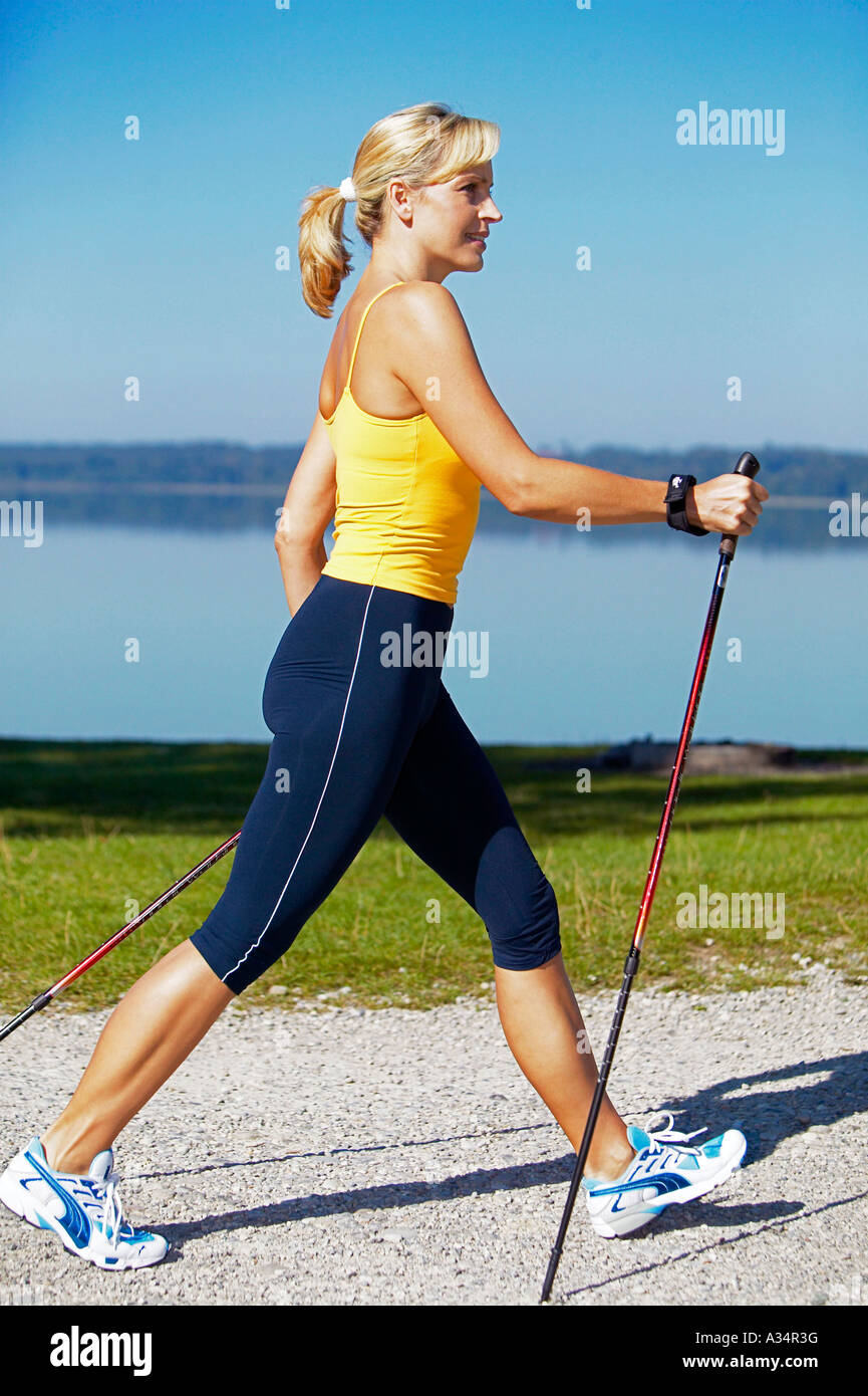 woman doing nordic walking, blonde Frau beim Nordic Walking Stock Photo ...